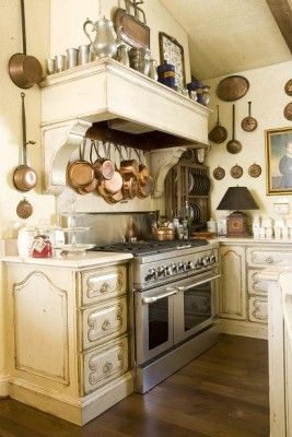 French cottage kitchen with over-size stove, small lamp on countertop, and the warmth of art and old silver & copper on display. Commode Shabby Chic, Vintage Country Kitchen, Old Fashioned Kitchen, Kitchens Ideas, Country Kitchen Cabinets, Kitchen Retro, Vintage Kitchens, Country Kitchen Designs, French Country Kitchens