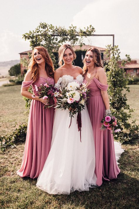 Bride in Structured Bustier Rue de Seine Fox Gown with Floral Appliqué Detail and Off The Shoulder Straps | Pronovias Chiffon Overskirt | Pink, Purple and White Wildflower Bouquet with White Trailing Ribbon | Bridesmaids in Dusky Pink ASOS Dresses with Ruched Bodice and Off-Shoulder Straps | Wooden Wedding Arch with Botanicals | Il Rigo Agriturismo | Rue de Seine Wedding Dress with Pronovias Overskirt, Personalised Place Setting Illustrations and Sweetheart Table | Samuel Docker Photography Dusky Pink Bridesmaid Dresses, Dusky Pink Bridesmaids, Dusky Pink Dress, Blue Bridesmaid Dresses Short, Rue De Seine Wedding Dress, Dusty Pink Bridesmaid Dresses, Blush Pink Bridesmaid Dresses, Indian Bridesmaid Dresses, Advice For Bride