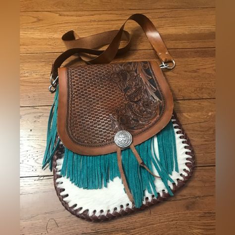 This Purse Was Purchased At A Native American Powwow In The Florida Area Some Years Ago. It’s In Perfect Condition And Looks Brand New. It’s Artist Made From One Piece Of Tooled Full-Grain Leather, Cow Hide, Teal Suede Fringe, And Hand Stitched With Leather Braiding All Around. The Purse Is Flat But Deep. Size Is 13x11 And The Strap Is 41 Inches Long. It’s A Beautiful Bag. Sales Go Toward Helping A Senior Widow Downsize Into A Smaller Home. We Have A Smoke Free Home. Thank You For Looking. Cow Purse, Native American Powwow, Leather Braiding, Handcrafted Bags, Cross Body Purse, Craft Bags, Suede Fringe, Cow Hide, Leather Projects