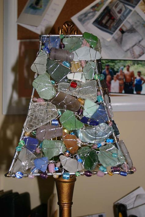 A friend of mine has been collecting sea glass for quite a while and wanted to do something with it so she asked if I could construct a lampshade out of the seaglass and some beads. I think it is turning out pretty well.....when it's dark in the room and you turn on the lamp it casts some really neat shadows on the walls. I might just have to make another one for myself:o) Sea Glass Lamp, Sea Glass Ideas, Sea Glass Crafts, Glass Lamp Shade, Broken Glass, Beach Crafts, Sea Glass Art, Glass Ideas, Beach Glass