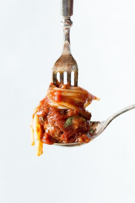 a spoon holding a small portion of spaghetti and a meatball with a fork on top. Fresh Pasta Photography, Pasta Dinner Party Aesthetic, Pasta Styling, Spaghetti Aesthetic, Meatball Spaghetti, Spaghetti Art, Sauce And Meatballs, Pasta Photography, Spaghetti Meatball Recipes