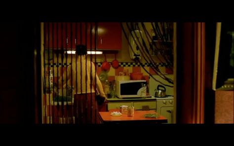 red pots on wall, bead curtain, red cabinets Amelie Apartment, Clue Movie, Red Cabinets, Bead Curtain, Santa's House, Colorful Apartment, Retro Room, Movie Set, Movie Shots