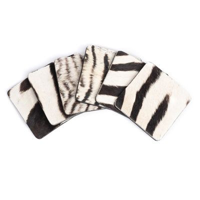 Our coasters are individually stitched by hand in the natural genuine zebra hide. These coasters come in a set of six, wrapped in a complimentary leather tie. As these are genuine animal hide, the coasters are waterproof and extremely durable. Due to the use of natural materials, each piece is unique and may vary slightly from the image shown. Ngala Trading Co. Zebra Hide Coaster with Tie - Coasters & Trivets in Brown | Size 4.0 D in | Perigold Zebra Hide, Animal Hide, Unique Coasters, Leather Tie, Candle Sticks, Beaded Chandelier, Egg Designs, Cape Town South Africa, Summer Gifts