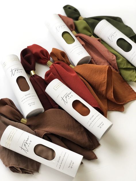 A life essential for you to take anywhere, each scarf is made from 100% washable-silk, has a hand-rolled and hand-sewn edge. Meant to be lived-in, worn, and washed, our hand-dyed heirloom scarves have a bit of magic in their making. 'The Hankie' is our smallest silk scarf: approximately 15 inches x 15 inches. Soft in hand and light in weight, it's the perfect everyday accessory. Versatile and functional, it can be used as a pocket square, napkin, bandana, purse tassel, or a traditional hankie —y Textile Packaging Ideas, Packaging For Scarf, Scarf Packing Ideas, Silk Scarf Packaging, Hijab Packaging Ideas, Scarf Packaging Ideas, Shawl Packaging, Bandana Purse, Scarf Packaging