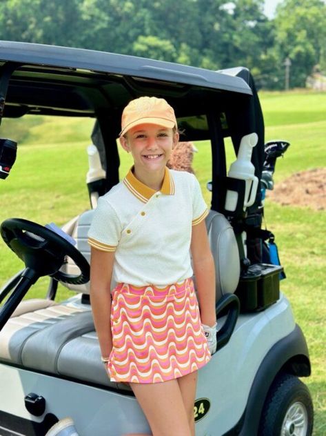 Find your golfing bliss with our Marie Birdie Go Ask Alice Polo in Cream paired perfectly with the Go Ask Alice Skort in Hypnotic Gold!  This teen girl's radiant smile says it all - effortless style meets pure joy on the golf course. Elevate your game and fashion sense today! Girl Golf Outfit, Go Ask Alice, Girls Golf, Pure Joy, Golf Outfit, Birdy, Short Sleeve Polo, Fashion Sense, Upf 50