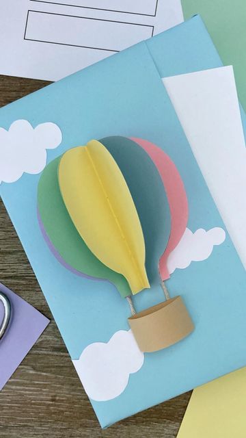 Gift Wrapping Love on Instagram: "☀️Full Video: Hot Air Balloon Themed Gift Wrapping | Paper Craft Ideas (🎈☁️Includes free printable templates for balloon, basket, and clouds) ➥ https://youtu.be/i8auKZEwb4c Link to video above. Please copy and paste or follow link in bio to the Gift Wrapping Love YouTube library. Enjoy! . . . #christmas #christmas2023 #kidscrafts #giftwrapping #giftwrappingideas #giftpackaging #giftwrappinginspiration #creativegiftwrapping #giftbox #hotairballooncrafts #papercrafts #hotairballoon" Themed Gift Wrapping, Bday Background, Gift Wrapping Tutorial, Balloon Basket, Free Printable Templates, Wrapping Paper Crafts, Creative Gift Wraps, Presents For Boys, Paper Craft Ideas