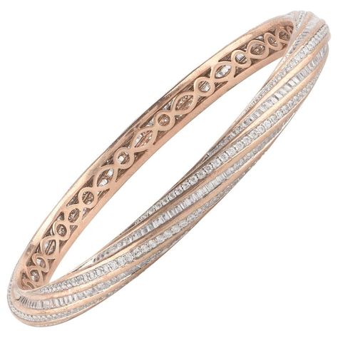 Designer diamond bangle crafted by our in-house experts in 18-karat rose gold and beautifully studded with 280 brilliant and 304 baguette cut natural diamond set in pave and channel setting. The diamonds are graded H-I Color, I2 Clarity. The diameter of the bangle is 57.00 x 57.00 MM. Metal color can be customized on request. This piece is made to order, please allow 2-3 weeks for manufacturing. Modern Bangle, Bracelets Diamond, Diamond Jewelry Set, Twisted Bangle, Rose Gold Bangle, Channel Setting, Bangles Indian, Stone Bangle, Bangles Jewelry Designs