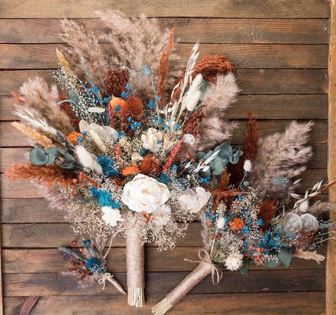 Best for fall autumn wedding. Teal blue, burnt orange, and eucalyptus color scheme. Natural dried flowers and 2 sola wood flowers.  The set includes a bride's bouquet, a bridesmaid's bouquet, boutonnieres for guests, dads, and men,  hand corsages for mom, grandmother, and bridesmaid. Also flower hair combs. https://www.etsy.com/listing/1732129162/  We have compositions for arches. Also, you will find more items in my store in this color scheme. You can send me your palette of colors and the bouq Rust Terracotta Wedding, Dark Teal Weddings, Teal Bouquet, Fall Bridal Bouquet, Bouquet Eucalyptus, Boho Wedding Colors, Country Western Wedding, Western Themed Wedding, Burnt Orange Weddings