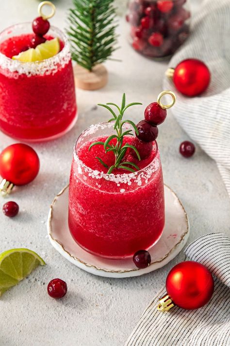 This frozen cranberry Margarita is a tequila cocktail perfect for the holidays. Serve this delicious drink on Thanksgiving and Christmas. For large parties, batch the drink mixture in advance. Then as needed, add it to a blender with ice and blend. 📌 Pin this easy cocktail recipe now. Cranberry Margaritas, Holiday Margaritas, Sweet Or Salty, Easy Cocktail Recipe, Festive Holiday Drinks, Cranberry Margarita, Christmas Party Drinks, Easy Alcoholic Drinks, Cranberry Juice Cocktail