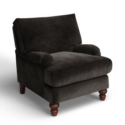 What better way to welcome traditional farmhouse charm into your living room than with a cozy armchair? This one features recessed arms and turned, tapered front legs in a warm brown finish. Integrated sinuous springs and a down + foam blend combine for comfort and support. Select from a variety of upholstery fabrics, hues, and patterns to compliment your décor scheme. Drape a throw over the back to make it even more inviting. Birch Lane™ Fabric: Nave Charcoal Performance Distressed Velvet Birch Upholstered Living Room Chairs, Rustic Accent Chairs For Living Room, Cozy Armchair, Family Den, Black Armchair, Grey Armchair, Upholstered Armchair, Family Movie, Traditional Farmhouse