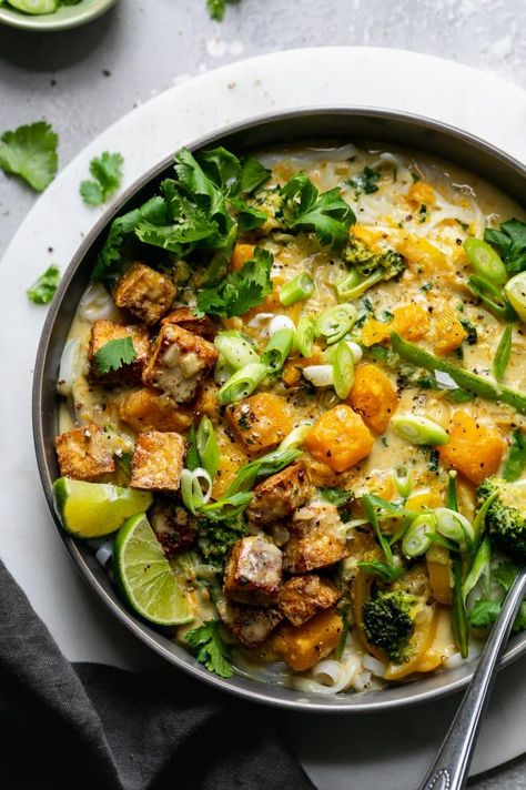 Butternut Squash Green Curry Rice Noodle Bowls are the ultimate healthy comfort food for busy weeknights. These bowls are filled with butternut squash, crisp veggies, rice noodles, and a silky smooth coconut milk green curry sauce. Lime juice, cilantro, and scallions brighten up this cozy dish and make it over-the-top delicious! #greencurry #vegetarian #vegan #plantbased #ricenoodles Green Curry Rice, Rice Noodle Bowls, Green Curry Sauce, Vegetable Noodles, Curry Rice, Fall Comfort Food, Rice Noodle, Healthy Comfort, Green Curry