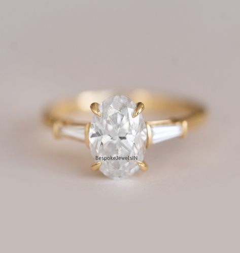 🐕 Big deals! 1.80 TCW Colorless Oval Cut Moissanite Wedding Ring in 18KT Yellow Gold | Three Stone Engagement Ring | Side Stones Baguette Cut Ring only at $125.0 Hurry. #WeddingRing #BaguetteRing #EngagementRing #YellowGoldRing #MoissaniteRing #ProposeRing #3StoneRing #OvalMoissaniteRing #GiftForHer #PlatinumRing Oval Diamond With Baguette Side Stones, Oval Engagement Ring Baguettes, Oval Engagement Ring With Side Baguettes, Oval Engagement Ring With Tapered Baguettes, Oval With Tapered Baguettes, Oval And Baguette Engagement Ring, Oval With Baguettes Ring, Oval Engagement Ring With Baguettes, Oval Cut Diamond Rings