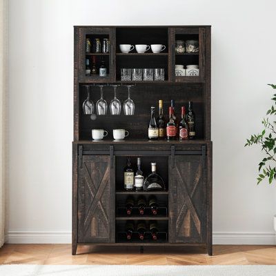 【Multifunctional and Practical Wine Cabinet】The farmhouse family bar furniture with sliding barn doors provides convenient access to the cabinet and saves space. The sliding doors, adorned with farmhouse accents, create an elegant farmhouse ambiance in your living space. This versatile piece can be used as a bar cabinet, kitchen pantry, display cabinet, coffee bar, microwave stand, kitchen cupboard, bookcase, or storage cabinet. Gracie Oaks Color: Black | Gracie Oaks Meshah Sideboard w / Bar Hut Rustic Buffet Cabinet, Symmetrical Aesthetic, Rustic Wine Cabinet, Alcohol Cabinet, Cabinet Coffee Bar, Coffee Bar Cabinet, Farmhouse Bar, Farmhouse Coffee Bar, Wine Bar Cabinet