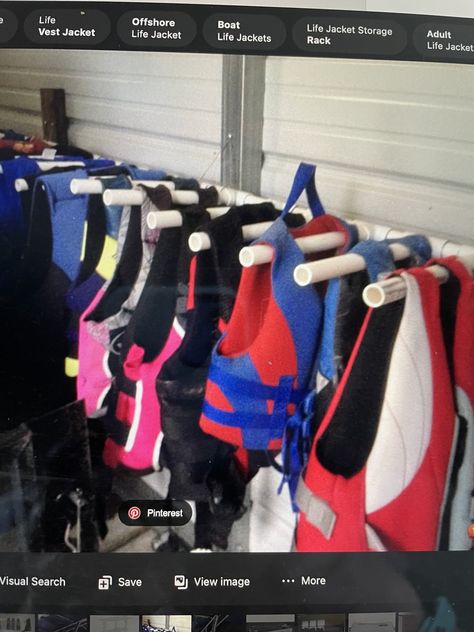 Life Jacket Storage Ideas Garage, Life Vest Storage Ideas, How To Store Kayaks In Garage, Lifejacket Storage Garage, Life Jacket Storage Ideas, Life Jacket Drying Rack, Life Jacket Rack, Life Jacket Storage, Lake Toys