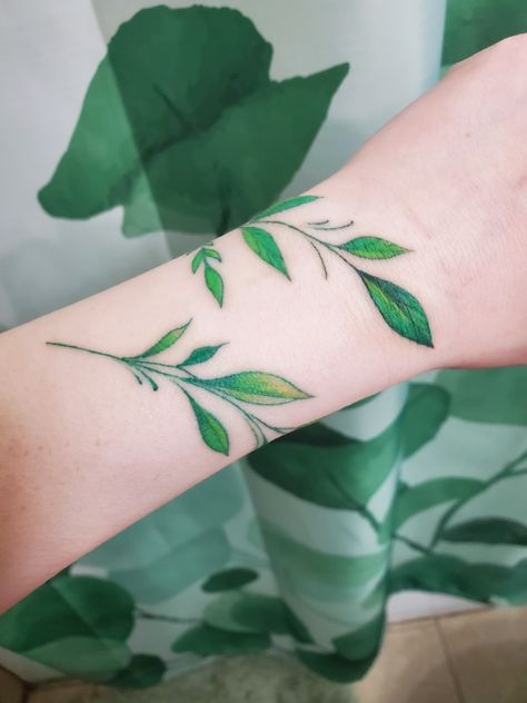 Hand Tattoos For Women Plants, Green Ivy Tattoo, Wrist Ivy Tattoos, Green Vine Tattoo Arm, Poison Ivy Leaves Tattoo, Leafy Wrist Wrap Tattoo, Leafy Arm Wrap Tattoo, Vine Wrap Tattoo, Magical Tattoos