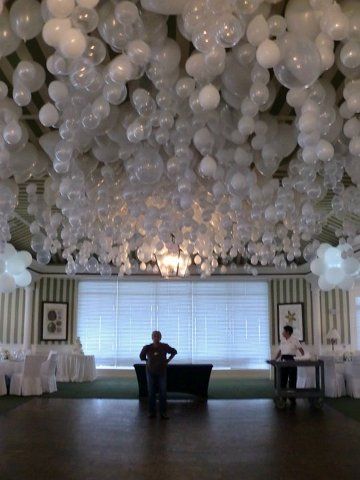 DIY: For a Fairy Tale Setting (or a backwards party), get tons of friends to help blow up balloons and then hang them upside down (on Pinterest someone suggested putting a marble inside each one). Damage to ceiling - unknown. Wedding Ceiling at the Port Royal Club, Naples FL by Bayside Balloons Private Events here (link gone).            go naples. White Balloons, E Card, Here Comes The Bride, Pom Poms, Upside Down, Marry Me, Future Wedding, Party Time, Party Planning