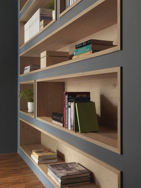 To make the built-in bookshelves on this deep grey wall stand out, the shelves were lined with wood to add a natural touch in the office interior. #shelving #BuiltInShelving #WoodLinedShelving #WoodLinedBookshelf Interior Kantor, Muebles Living, Interior Vintage, Regal Design, Diy Casa, Bookshelf Design, Built In Bookcase, घर की सजावट, Design Del Prodotto