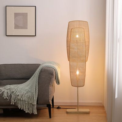 This eye-catching 2-light floor lamp illuminates any room with its distinctive silhouette and breezy boho style. Standing at 55" tall, it features fan-like wicker rattan panels that come in a natural finish for a mid-century modern vibe we love. The dual lights (60W max, sold separately) help to create a cozy corner in your living room or a reading nook in your home office. A foot switch on the rectangular wooden block base makes it easy to operate, even with your hands full. This lamp is also d Spa Like Bedroom, Listening Lounge, Wicker Floor Lamp, Contemporary Bohemian, Beach Living Room, Modern Rustic Decor, Stand Light, Life Aesthetic, Beachcrest Home