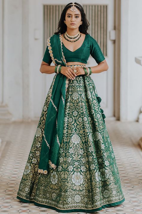 Featuring a green lehenga in pure banarasi and raw silk base with golden and silver zari. It is paired with a matching blouse, an organza coin embroidery dupatta, and a belt.  FIT: Fitted at bust and waist. COMPOSITION: Pure banarasi, Raw silk, Organza. CARE: Dry clean only. Banarsi Lehenga, Lehenga Designs Latest, Trendy Lehenga, Latest Lehenga Designs, Embroidery Dupatta, Saree Ideas, Banarasi Lehenga, Cotton Saree Blouse Designs, Simple Lehenga