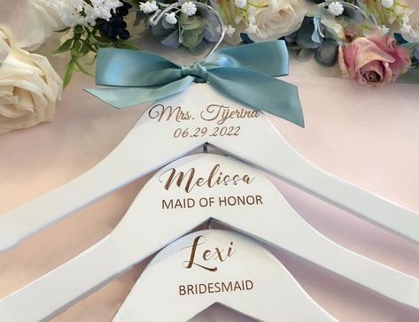 PRICES MAY VARY. Made from the finest quality white lacquered beech wood and finished off with a chrome hook, this dress hanger looks classic and stylish. Make your wedding day even more special with our personalized hangers engraved especially for you. Not only such hangers will look amazing in your wedding photos, but will also make a wonderful keepsake for you and your bridesmaids. Such an amazing idea to make your big day memorable for your friends for years to come Each hanger is individual Personalized Bridesmaid Hangers, Bridesmaid Hanger, Custom Wedding Hangers, Engraved Hangers, Bridal Hangers Personalized, Bridal Coat, Hanger Wedding, Bridesmaid Hangers, Bridal Shower Gifts For Bride