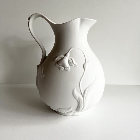 "This pitcher, jug or vase is stunning!  The 3D jonquil and leaf design on this bisque porcelain known as parian porcelain would be a lovely edition to almost any décor.  It is simple yet makes a statement.  So lovely as part of a white on white décor theme.  DIMENSIONS: 7\" wide x 9\"  tall   CONDITION: Excellent, no chips or cracks For more vases click here: https://etsy.me/3xPHpNm Return to the Vintagerous glass home page here: http://www.etsy.com/shop/Vintagerous ID#: 24-4-680-24-404-A-22" Large Wheel Thrown Pottery, Ceramic Vase Texture, Minimal Pottery, Textured Ceramics, Floral Ceramics, Jug Design, Carving Clay, Slab Vase, Clay Hands