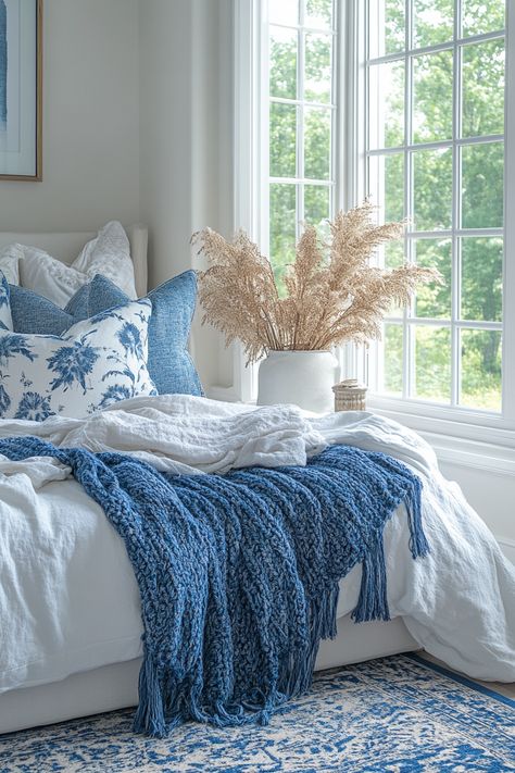 Embrace the cozy and stylish white and blue bedroom aesthetic. Explore different shades of blue for walls, bedding, and accents. Incorporate natural textures, soft lighting, and comfortable furniture to create a warm and inviting space. Discover a range of white and blue bedroom ideas to achieve a serene and comfortable haven for relaxation and rest. Cozy Blue And White Bedroom, Room Decor Bedroom Blue And White, Royal Blue And White Bedroom, Blue And White Bedding Ideas, Light Blue Bedding Aesthetic, White Blue Bedroom Ideas, Bedding Ideas Blue, Blue And White Apartment, Bedroom Blue Aesthetic