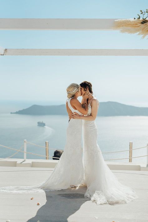 Two brides in boho lace wedding dresses share their first kiss as a married couple for lesbian wedding Lesbian Wedding Suit, Lesbian Wedding Outfits, Personal Wedding Vows, Outdoor Wedding Dress, Bridal Party Attire, Rock Dresses, Two Brides, Boho Wedding Dress Lace, Santorini Wedding