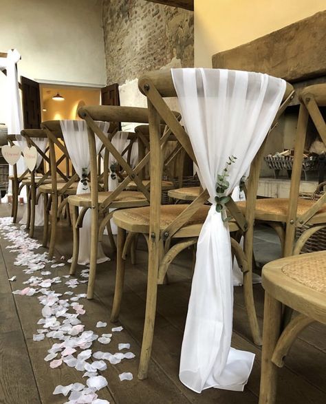 Beautiful white chiffon drapes with sprig of eucalyptus on a cross back chair. Created by Ambience Teesside at Middleton Lodge. Chair Decor | Wedding Chairs | Wedding Chair Decor | White Wedding Colour Palette | Rustic Wedding | Foliage Wedding | Wedding Decor | Wedding Decorations | Wedding Chair Decorations | Wedding Decor Ideas | Wedding Decor Inspiration | Wedding Theme Chair Decor Wedding, Lodge Chair, Wedding Chair Decor, Wedding Foliage, Cross Back Chair, Wedding Chair Covers, Diy Chair Covers, Middleton Lodge, Spring Wedding Color Palette