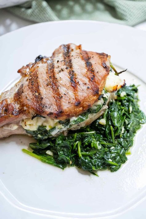 Delicious, moist, and tender grilled stuffed pork chops in less than 30 minutes stuffed with sauteed spinach, garlic, and feta cheese. This pork chop oozes feta and juices and can be served on a pile of sauteed spinach. With an easy stuffed pork chops recipe and flavorful grilled pork chop stuffing, you'll have a meal that's both satisfying and simple! Italian Baked Ziti, Sauteed Spinach Garlic, Italian Braciole, Grilled Lemon Pepper Chicken, Easy Italian Dinner, Cheese Pork Chops, Italian Soup Recipes, Stuffed Pork Chops, Easy Bbq Chicken