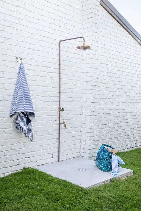 The outdoor shower at the Burleigh Beach Retreat. The shower was made by our plumber using a shower head from @abiinteriors. The palm tree hooks are from @pineappletrader Photo by Elouise van Riet-Grey. #outdoorshower #coppershower #beachshower Outdoor Shower Head, Hamptons Garden, 1980s House, Outdoor Shower Beach, Bungalow Cottage, Manzanita Tree, Garden Shower, Beach Shower, Beach Retreat