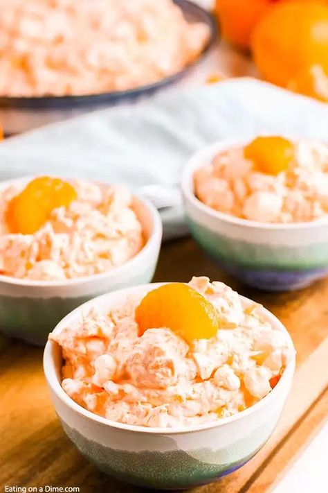 Mandarin orange jello salad recipe with cottage cheese has just 6 ingredients and takes minutes to prepare. Whipped topping, jello, manderine and more make this salad delicious and fluffy. Enjoy this tropical salad with pineapple and cool whip. #eatingonadime #mandarinorangejellosaladrecipe #mandarinpineapple Jello With Oranges, Orange Watergate Salad, Watergate Salad With Cottage Cheese, Mandarin Orange Salad Jello Cool Whip, Cool Whip Salad Recipes, Orange Fluff Salad Mandarin, Cool Whip Salads, Jello Cottage Cheese Salad, Mandarin Orange Jello