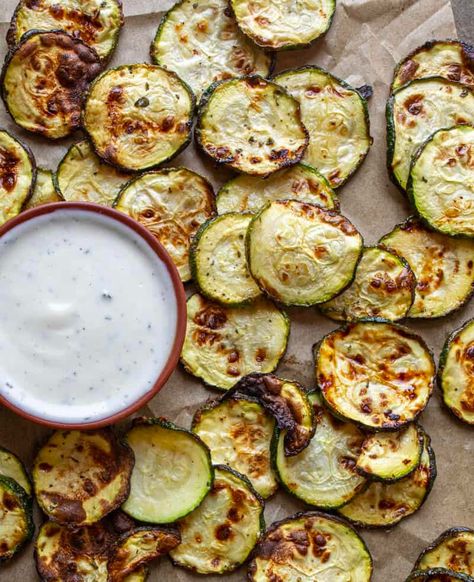 Ranch Zucchini Chips is a vegetable side dish made with sliced zucchini and dry ranch seasoning that is easy to make and serve. With just a few steps, you'll create delicious zucchini rounds with zesty ranch seasoning! Plus, you can even make these in the oven if you don't have an air fryer! Dehydrate Zucchini Chips, Air Fryer Zucchini Chips Healthy Snacks, Zucchini Chips Oven, Air Fryer Zucchini Chips Keto, Cool Ranch Zucchini Chips, Ranch Zucchini, Zucchini Rounds, Sliced Zucchini, Zesty Ranch