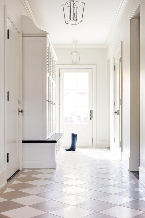 Darlana Lantern illuminates a foyer designed with white and taupe harlequin floor tiles, white built ins and cabinet storage space. Harlequin Tile, Harlequin Floors, White Built Ins, Mudroom Flooring, Foyer Flooring, Entrance Way, Mudroom Design, Foyer Design, Laundry Room Design