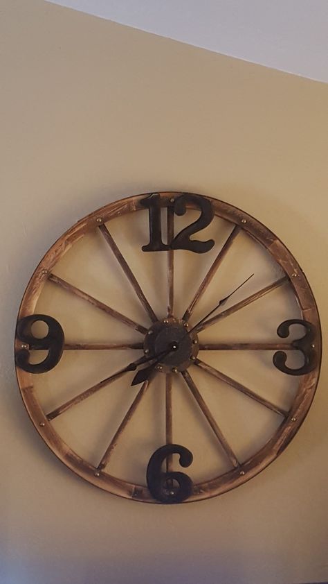 We finally finished our wagon wheel clock! I love it! Old Wagon Wheel Ideas Decor, Wagon Wheel Clock, Antique Wagon Wheel Ideas, Wooden Wagon Wheel Ideas, Wooden Wheel Decor, Wagon Wheel Decor Indoor Wall Ideas, Old Wheel Ideas, Wagon Wheel Decor Indoor, Old Wagon Wheel Ideas