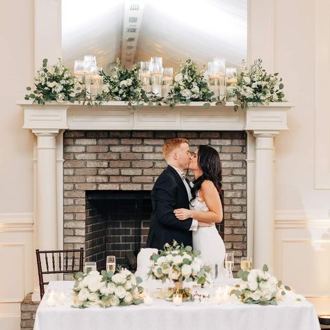 Fireplace Mantel Wedding Decor Bride And Groom Table In Front Of Fireplace, Fireplace Wedding Reception, Fireplace Sweetheart Table, Fireplace Ceremony Wedding, Mantle Wedding Decor, Wedding Mantel Decor, Wedding Mantle Decor, Fireplace Wedding Decor, Mantel Candles