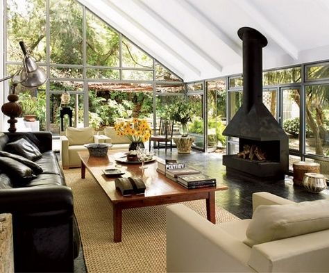 Sunroom With Fireplace, Eclectic House, Freestanding Fireplace, Mediterranean Homes, Low Tables, Spacious Living Room, Fireplace Design, Outdoor Rooms, Architectural Digest