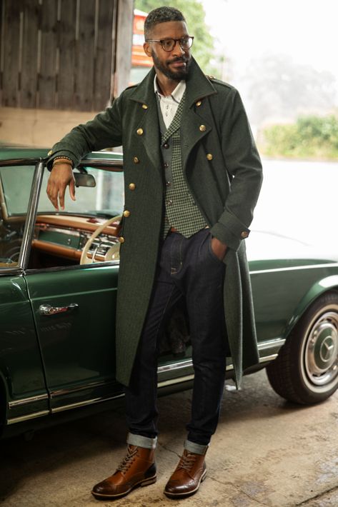 A man wearing a dark green military style coat with a green checked waistcoat and brown lace-up boots. Military Coat, Classic Coats, Joe Browns, Tailored Blazer, Men's Collection, Men's Style, Long A Line, First Look, In Time