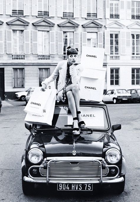 Christy Turlington personifies luxury as she sits atop a Mini Cooper with her legion of shopping bags wearing a ruffle sleeved button down tweed blazer as part of her head-to-toe Chanel attire in the editorial ‘Rive Paris!’ shot by longtime friend of the model photography legend Steven Meisel for Vogue Italia February 1992. Bridget Bardot, Mode Chanel, Tim Walker, Steven Meisel, Linda Evangelista, Claudia Schiffer, Christy Turlington, Ansel Adams, Chanel Vintage