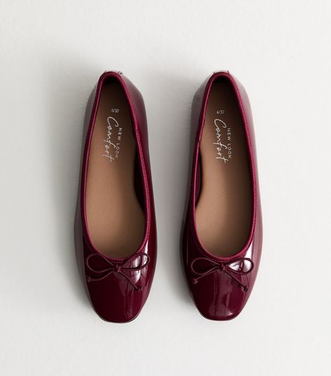 New Look Burgundy Patent Leather-Look Ballerina Pumps. An easy everyday staple, these pared-back ballet flats are shaped from smooth leather-look material with a. Comfort insole for a secure, comfortable fit. Material: patent leather-look finish Fit: standard Shoe Style: ballet flat Colour: burgundy Fastening: slip on Design: round toe, bow embellishments, bound edges . Comfort: a range of styles designed with features such as cushioned padding, softer linings and flexible soles. Red Dress Boots, Burgundy Ballet Flats, Bow Embellishments, Burgundy Jeans, Ballerina Pumps, Burgundy Shoes, Wedding Guest Shoes, Ballet Pumps, Wide Boots