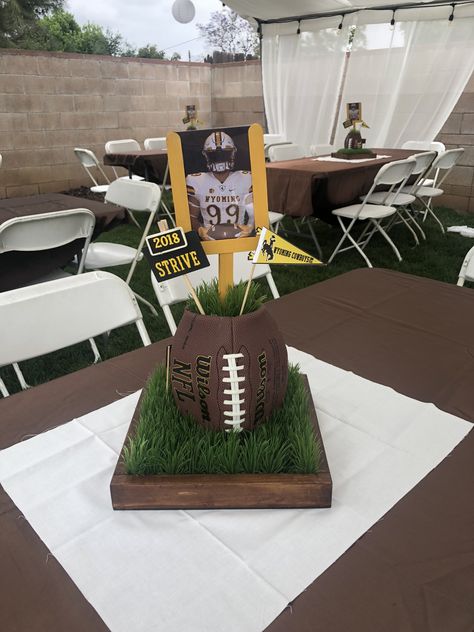 Football centerpieces Football Senior Serve Table Ideas, Football Treat Table, Football Sports Banquet, Football Memorial Ideas, Football Birthday Party Centerpieces, Football Theme Party Centerpieces, Graduation Football Centerpieces, Football Birthday Centerpieces, Football Theme Centerpiece Ideas