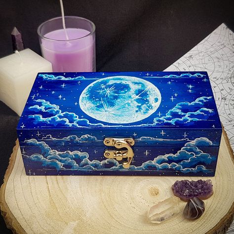 "This fully hand-painted wooden box features my original design of a full blue moon in a cloudy starry night sky. The box is covered with clear high-gloss lacquer to prevent the paint from scratching and for easy cleaning. It is ideal for tarot storage, altar decor, ritual and offering box, crystal storage, incense and herbs storage, as a jewellery box, pencils case box, stationery or arts and crafts storage, keepsake, etc. This box can be an excellent custom gift with the personalisation of the inner side of the lid. ► Felt Dividers ADD-ON https://www.etsy.com/uk/listing/1371752802/felt-dividers-add-on-jewellery-crystals ► As the boxes are made to order and completely hand-painted, minor changes to the design will occur. If you have any preferences (i.e. base black colour, fewer/more star Herbs Storage, Tarot Storage, Incense Herbs, Wooden Box Crafts, Full Blue Moon, Offering Box, Crystal Storage, Hand Painted Wooden Box, Arts And Crafts Storage