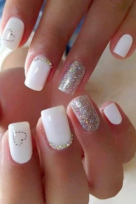 Looking for the best Valentine's Day nail designs? Check this post for the 70+ best Valentine's Day nail ideas that we can't wait to copy! White Nail Art Short Nails, Classy Nails Short Winter 2023, Gel Nails White Short, Gel White Nail Designs, Short White Valentines Nails, White Valentine’s Day Nails, Short White Gel Nails With Design, Cute Valentines Day Nails Acrylic Short, Heart Nails With Glitter