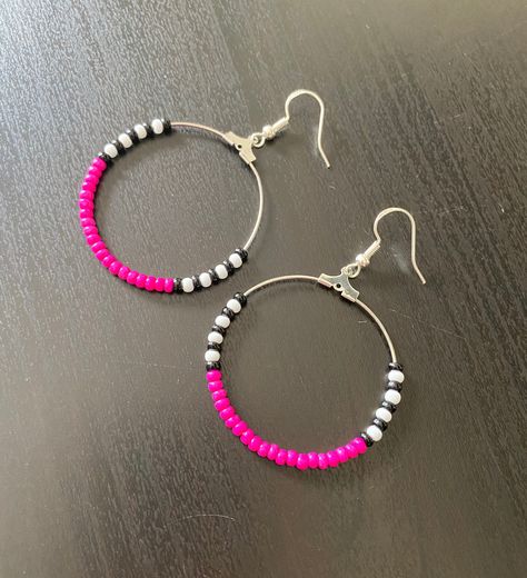 These smaller beaded hoops are perfect for everyday. They are 1.5 inches in diameter and their drop length is about 2.5 inches. Fuschia pink is the main colour with black and white bead accents. The silver earwires have rubber backings included. Body Jewelry Diy, Stretch Beaded Bracelets Diy, Simple Beaded Necklaces, Hot Pink Earrings, Handmade Leather Jewelry, Diy Wire Earrings, Fuschia Pink, Beaded Jewels, Handmade Earrings Beaded