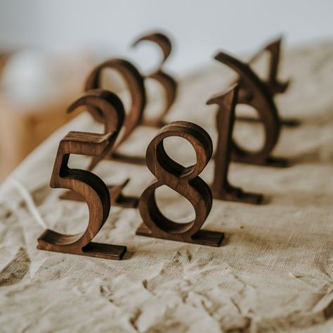 Rustic Wooden Wedding Table Numbers Add elegance and rustic charm to your wedding with our Wooden Wedding Table Numbers. Perfect for rustic-themed weddings, these custom wooden signs are not just functional but also beautifully designed to complement your table decor. They leave a memorable impression on your guests with their high-quality craftsmanship. Materials: Crafted from durable plywood in rustic brown and black, and sleek ashwood in white, our table numbers are built to last and look gre Wedding Table Number Ideas Rustic, Wedding Table Numbers Elegant, Wedding Table Numbers Unique, Fall Table Numbers Wedding, Farmhouse Table Wedding Decor, Farmhouse Table Wedding, Wooden Wedding Table Numbers, Table Wedding Decorations, Restaurant Table Numbers