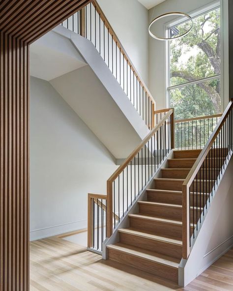 modern home staircase with white oak railings, hardwood flooring and a slat wood wall and ceiling design Slat Wall Entryway, Open Stairs In Living Room, Stairwell Design, Scandinavian Flooring, Acoustic Slat Wood Wall Panels, Wall Entryway, Metal Stair Railing, Moore House, Stairs In Living Room