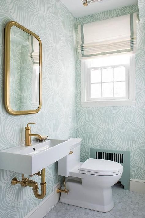 Sea foam green powder room feature walls clad in green Farrow & Ball Lotus Wallpaper lined with a Restoration Hardware Astoria Flat Mirror placed above a white porcelain rectangular wall mount sink fitted with brushed brass faucet alongside a carrera marble hexagon floor. Green Powder Room, Lotus Wallpaper, Very Small Bathroom, Bathroom White, Wall Mounted Sink, Studio Interior Design, Trendy Bathroom, Studio Interior, Residential Interior Design