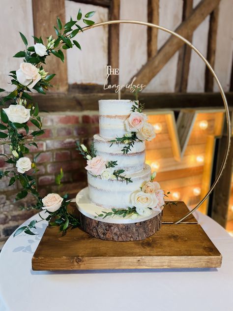 3 tier semi-naked wedding cake displayed on the hoop stand decorated with fresh flowers & personalised topper 3 Tier Naked Wedding Cake, Naked Wedding Cake With Flowers, Wedding Cake Neutral, Semi Naked Wedding Cake, Bridal Cakes, Semi Naked Cake, 2 Tier Wedding Cakes, Fancy Wedding Cakes, Wedding Cake Display