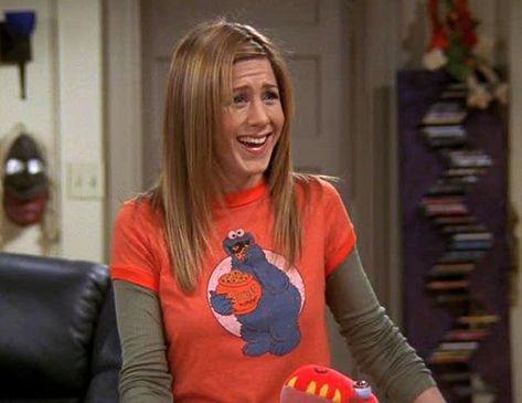 1990s: T-Shirts Over Long-Sleeve Shirts- HarpersBAZAAR.com Rachel Green Tshirt, Tshirt Over Long Sleeve Outfit, Shirt Over Long Sleeve, Rachel Outfits, Cookie Monster T Shirt, 1990s Fashion Trends, Worst Trends, Long Sleeve Shirt Outfits, Rachel Green Friends