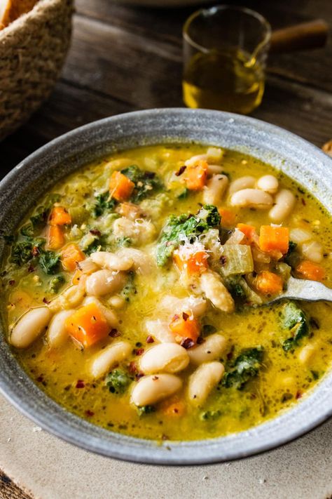 Tuscan white bean soup in a bowl. Portuguese White Bean Soup, Tuscan Robillita Soup, Tuscany Bean Soup, Tuscan Chicken White Bean Soup, Crock Pot Tuscan Soup, Simple Bean Soup, Tuscan Cannellini Bean Soup, Vegetarian Hearty Soup, Tuscan Chickpea Soup