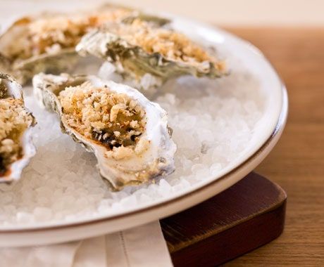 Oysters Bienville | Epicurious Oysters Bienville, Fat Tuesday Food, Baked Oyster Recipes, Louisiana Seafood, Ramekin Dishes, Oyster Recipes, Seasoned Bread Crumbs, Bon Appetite, Fish And Seafood